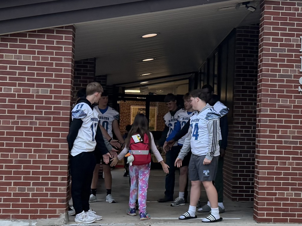 Members of the PHS Football team greating students on Friday