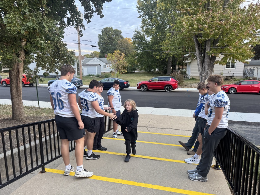 Members of the PHS Football team greating students on Friday