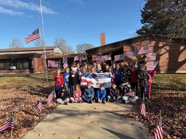 Lincoln Students posing outside of Lincoln after a fundraiser for the Disabled American Veterans