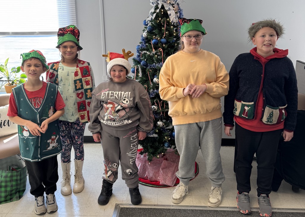 Mrs. Kull's Lifeskills class decorating the Christmas tree at the District Office