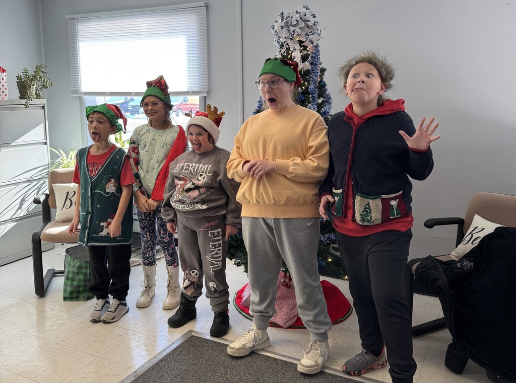 Mrs. Kull's Lifeskills class decorating the Christmas tree at the District Office