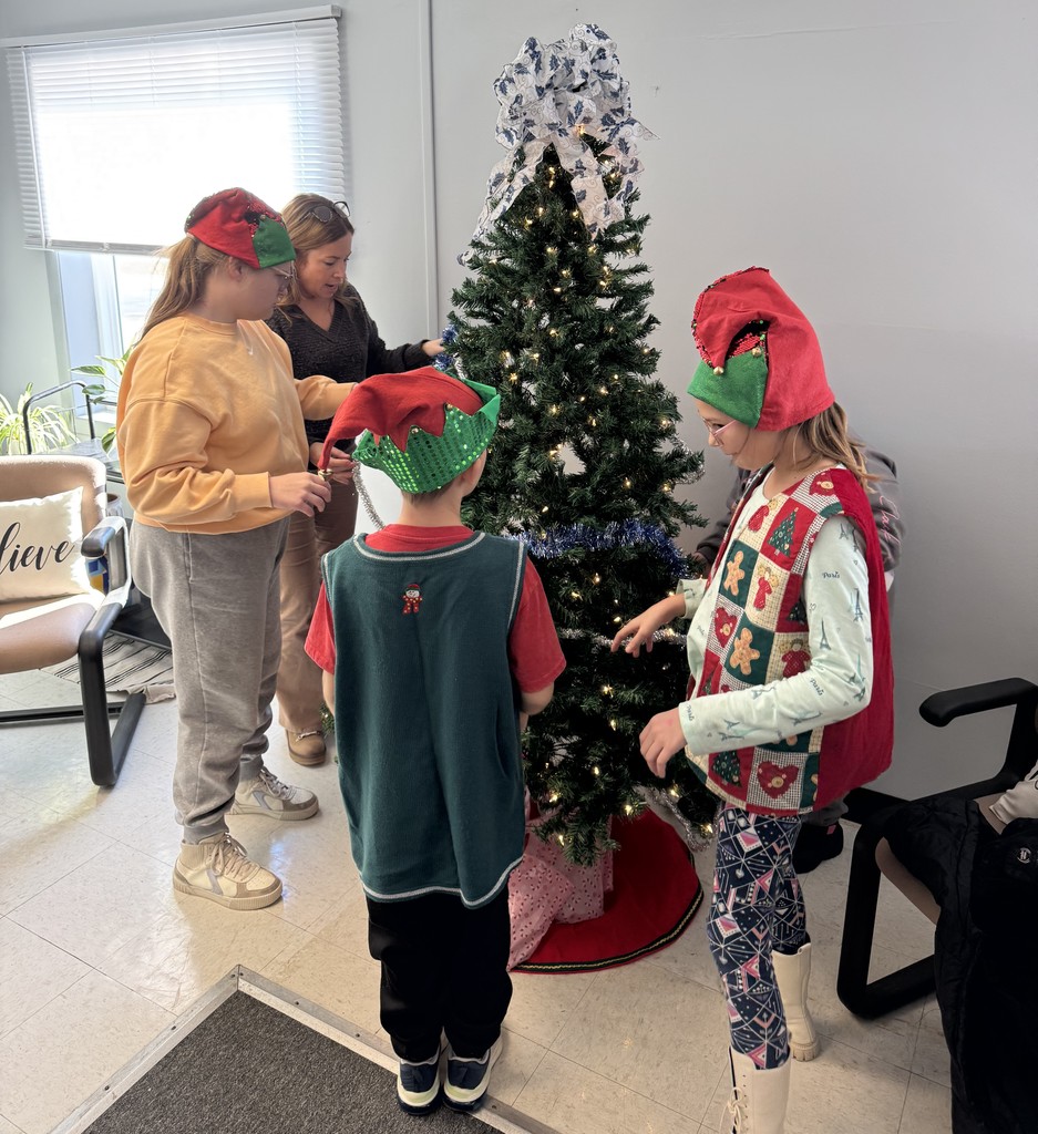 Mrs. Kull's Lifeskills class decorating the Christmas tree at the District Office