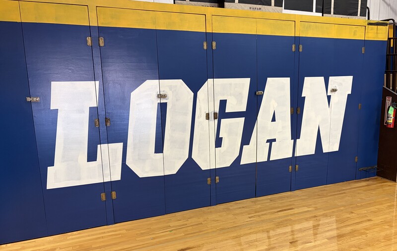 Cabinets in Pannebaker Gym reading Logan