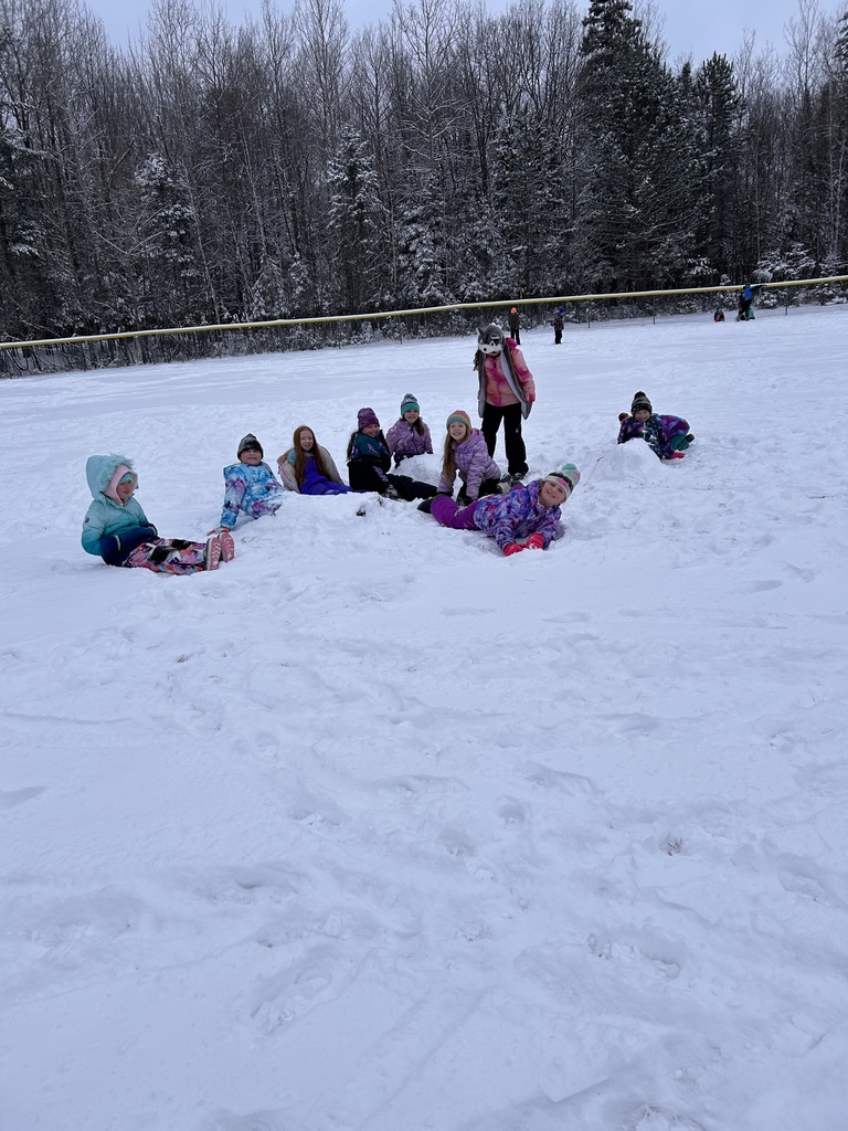 Girl laying down in the snow and smiling