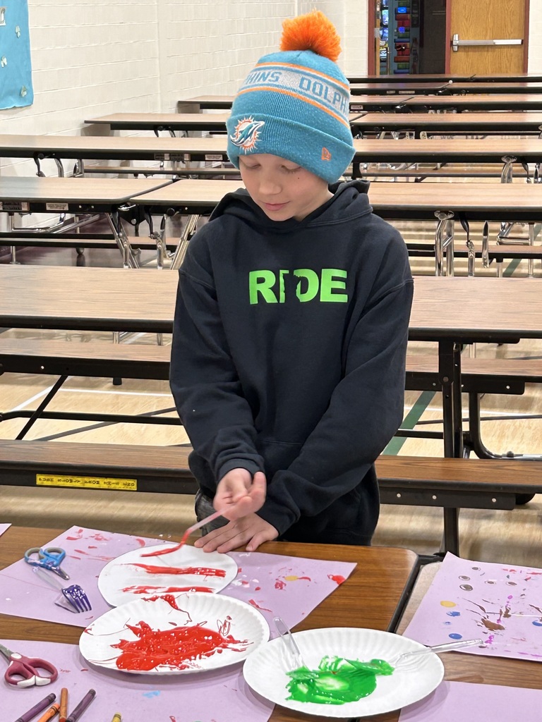 Boy painting his egg with a fork