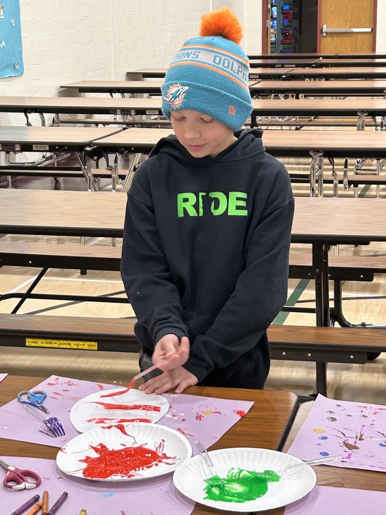 Boy painting his egg with a fork 