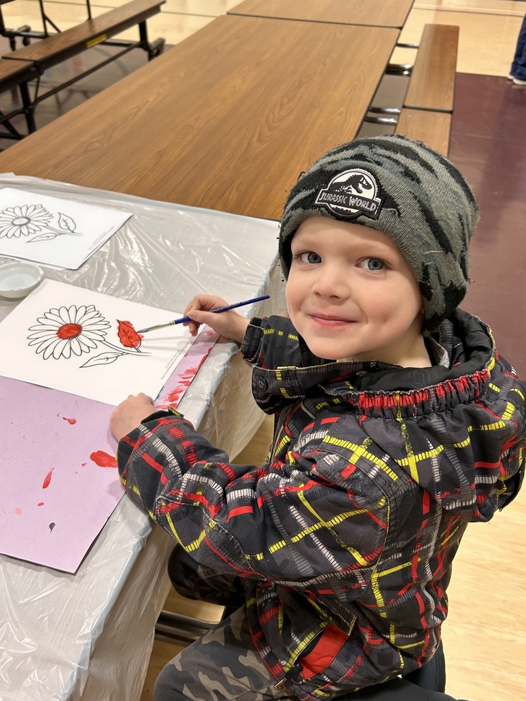 Boy painting his flower red