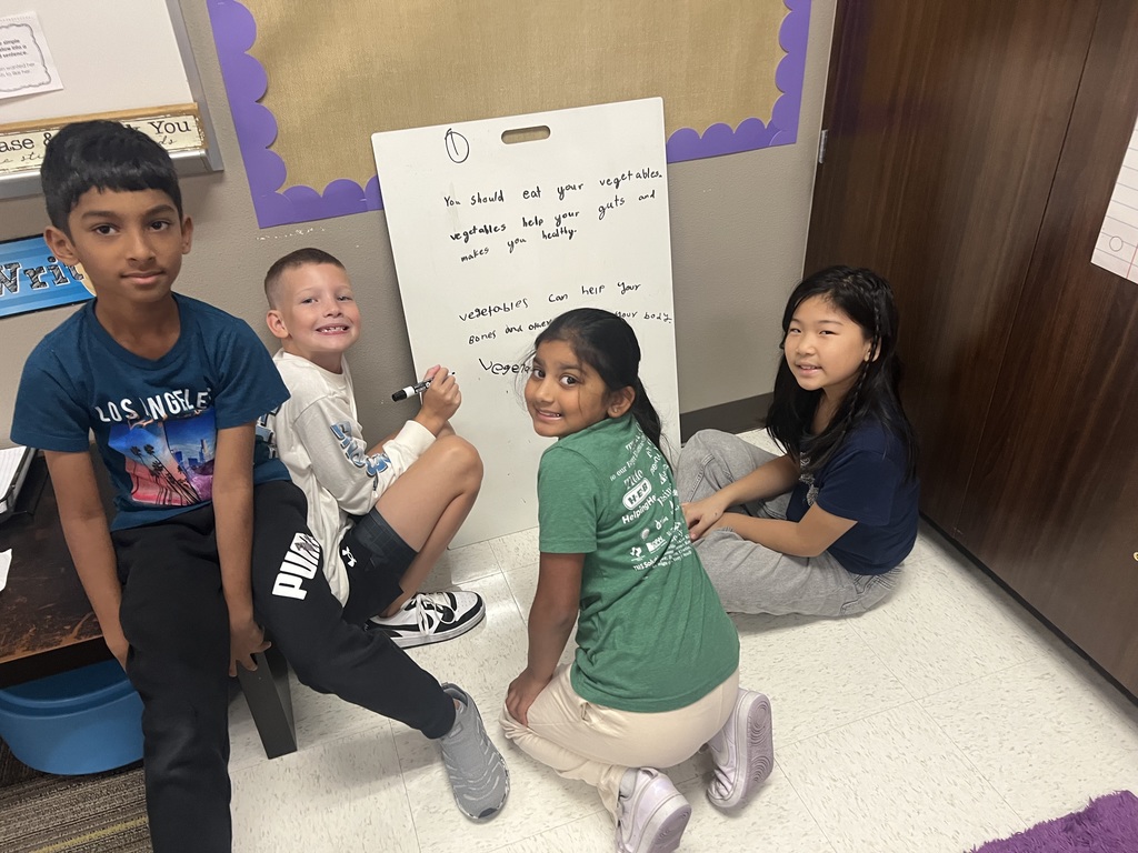 Fourth Graders writing SROs on Vertical Boards.