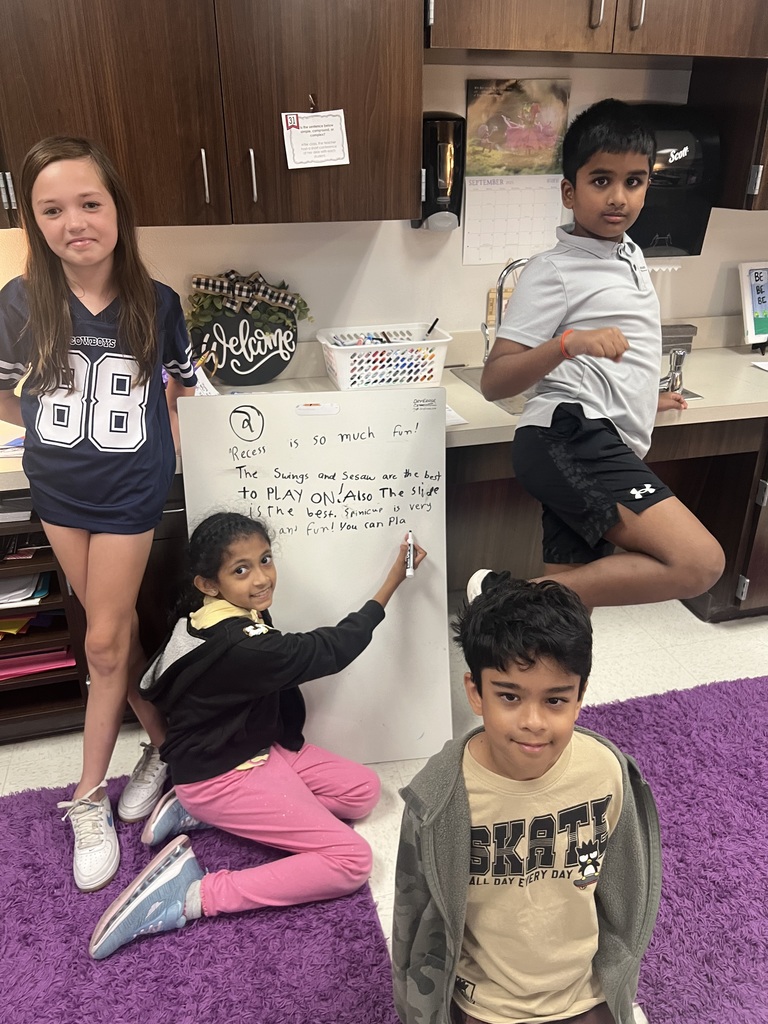 Fourth Graders writing SROs on Vertical Boards.