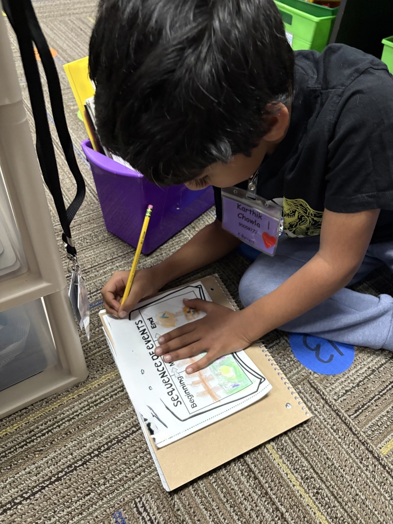 Kindergarteners writing.