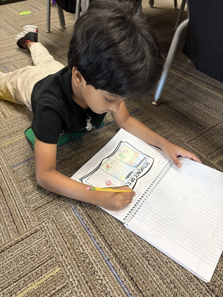 Kindergarteners writing.