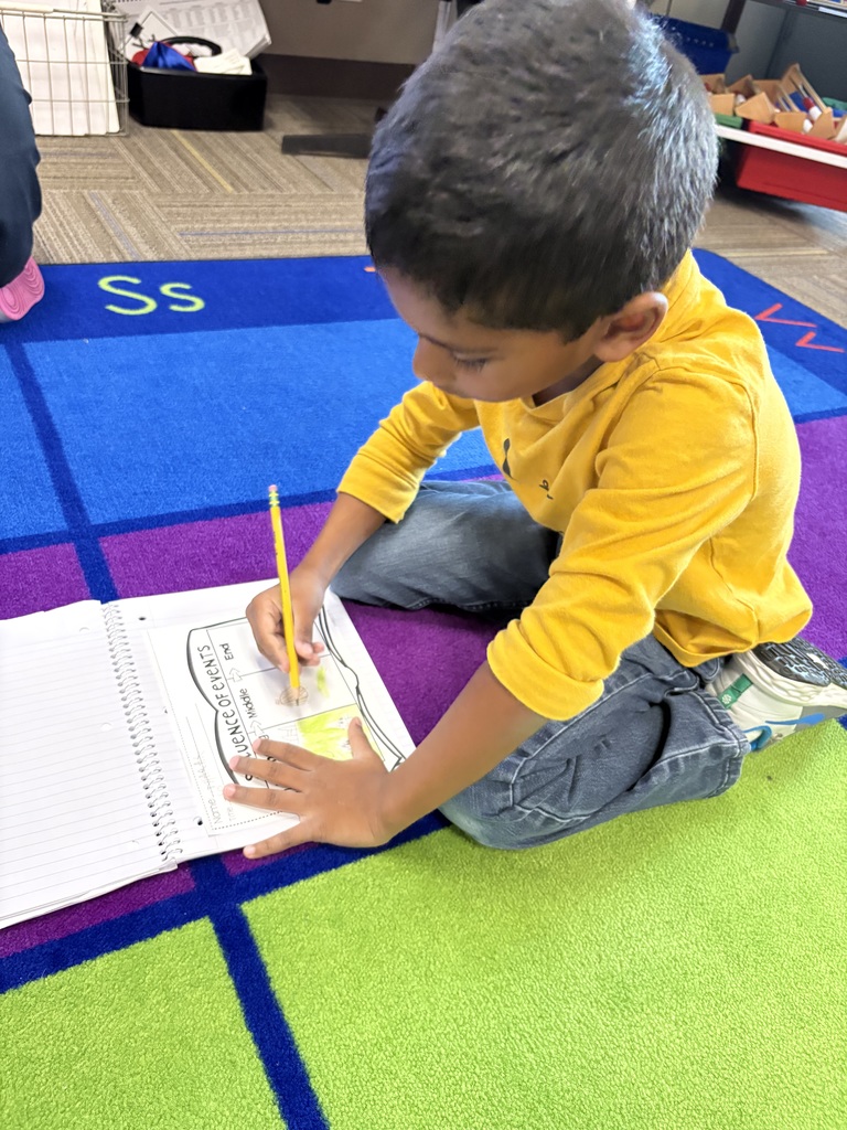 Kindergarteners writing.