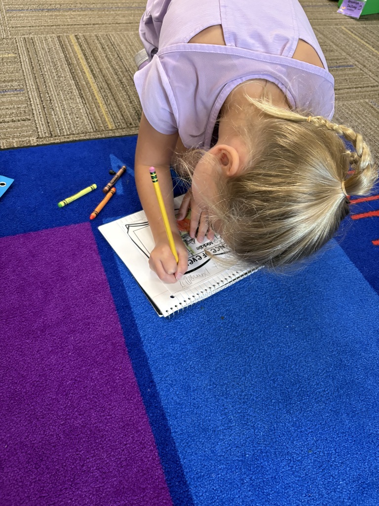 Kindergarteners writing.