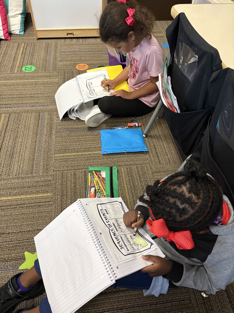 Kindergarteners writing.