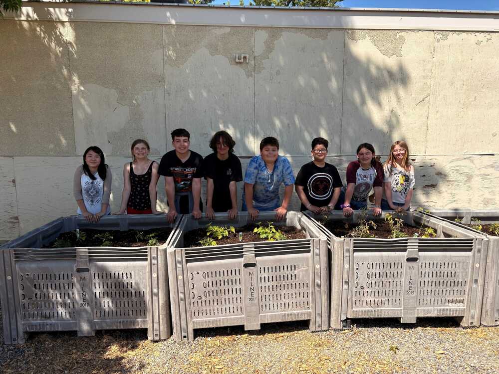 Students in front of raised planting beds.
