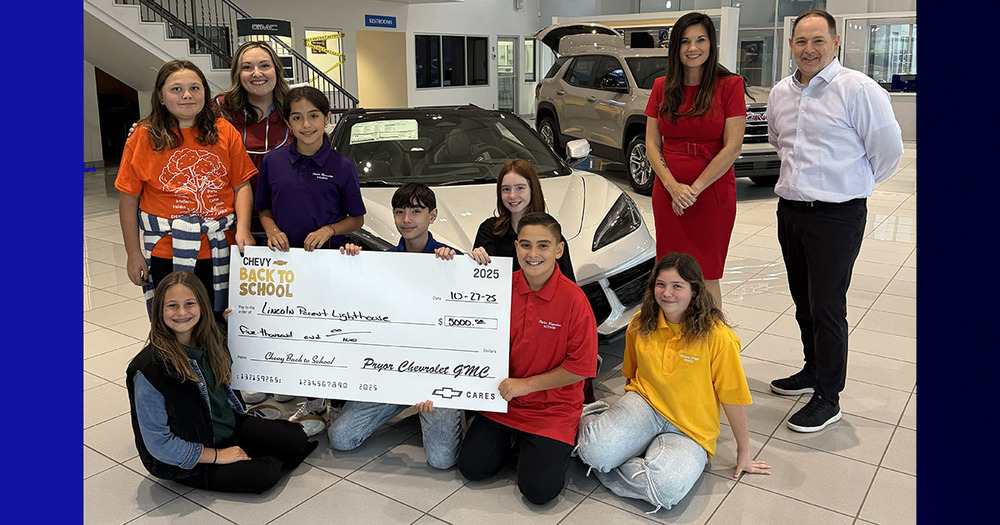 kids holding $5,000 check