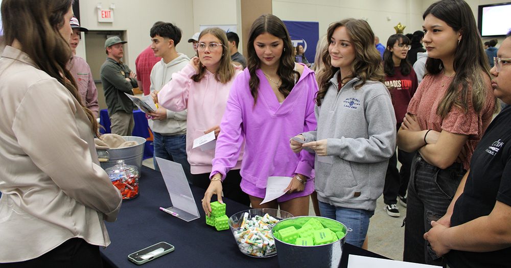 girls talking to recruiter