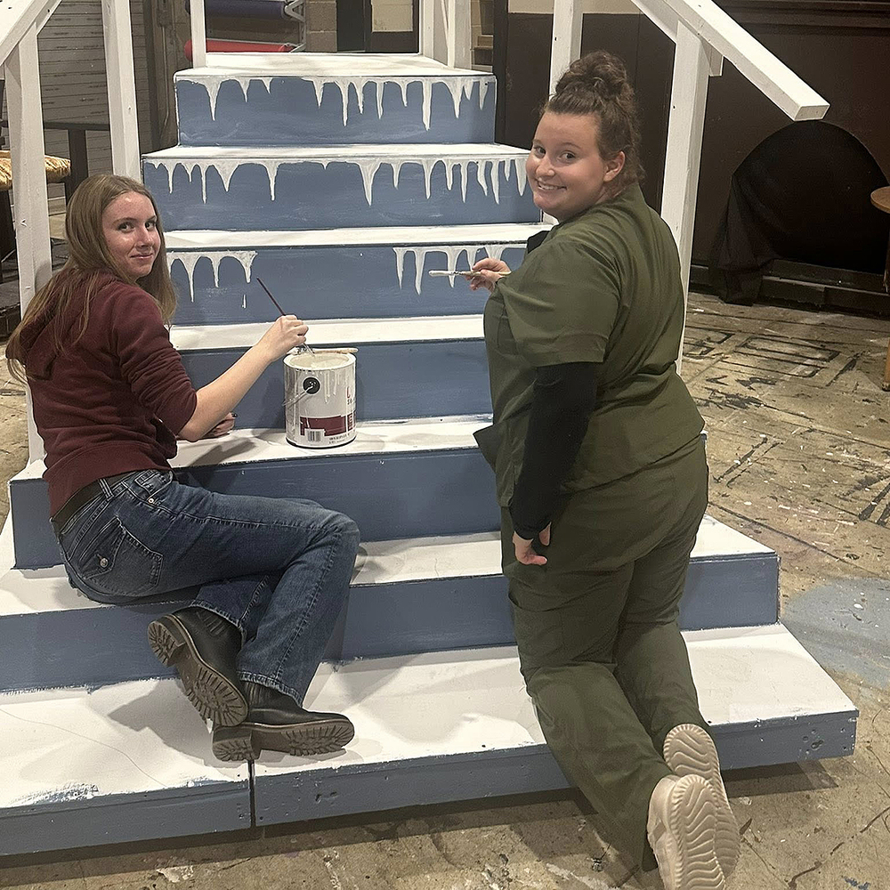 two girls painting stage