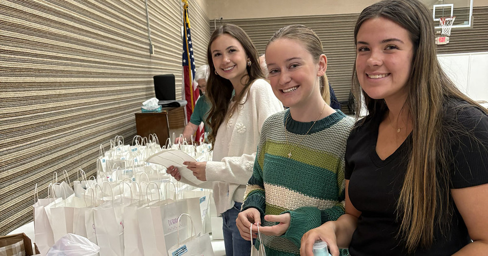 three students pack bags