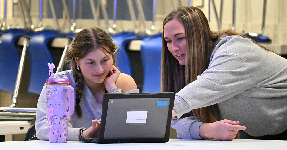 Gates helping student