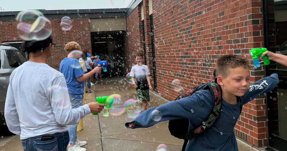 boy running through bubbles