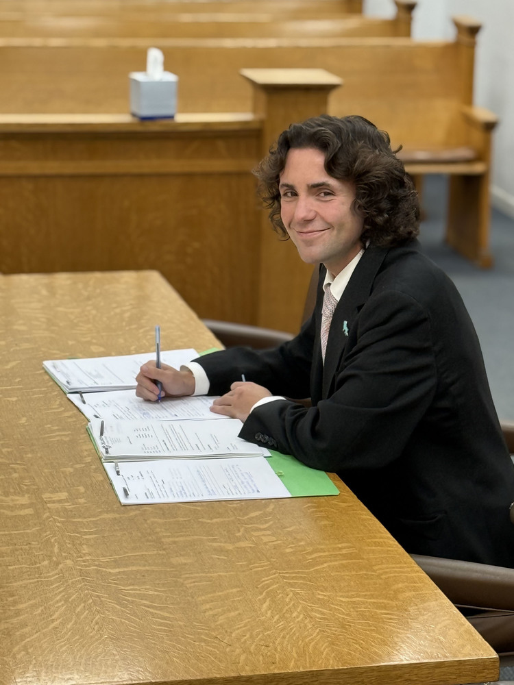 cade sitting at law desk