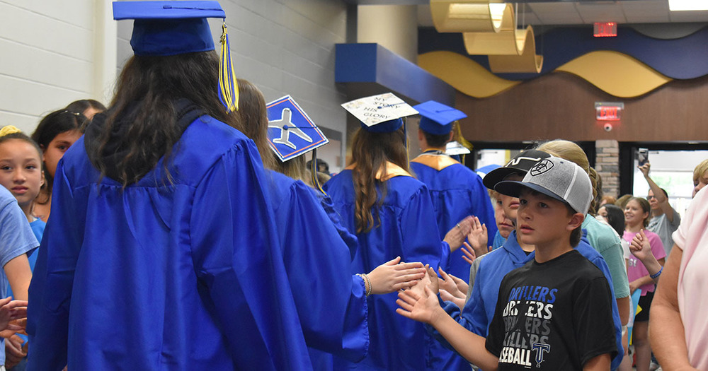 little boy taps hand of senior