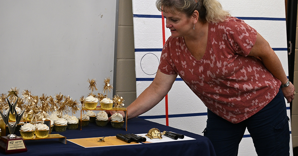 teacher reaches for cupcake
