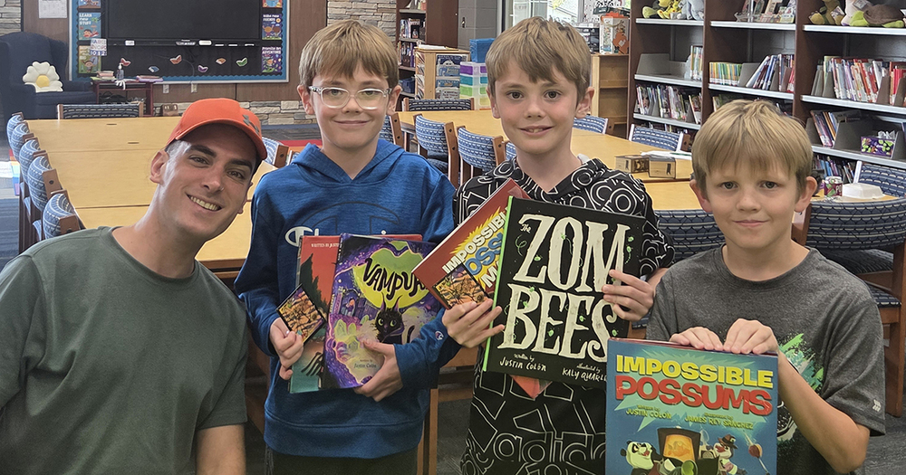 colon with three roosevelt students holding books