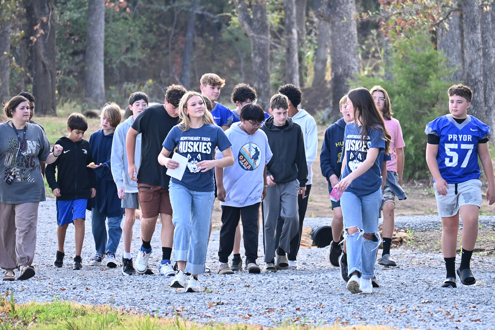group of students walking on gravel road