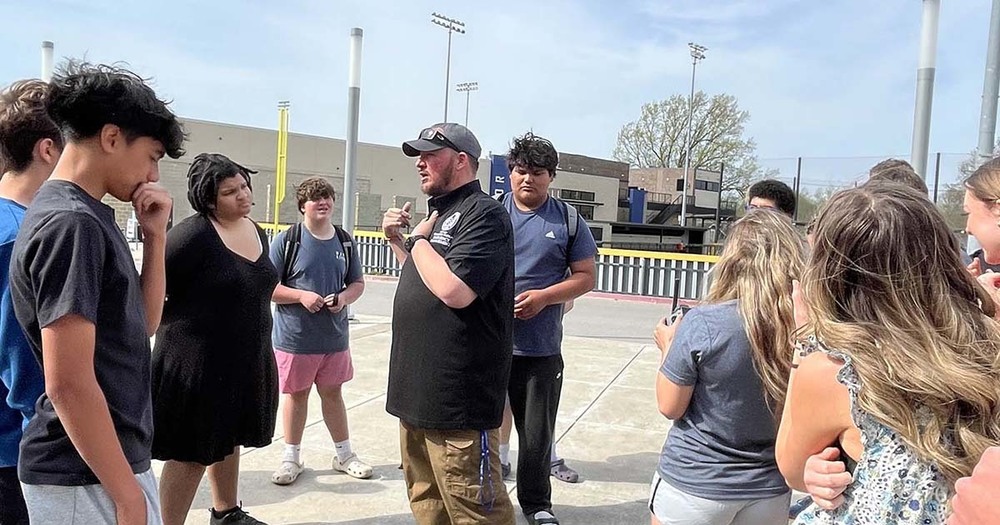 group of students listening to taylor