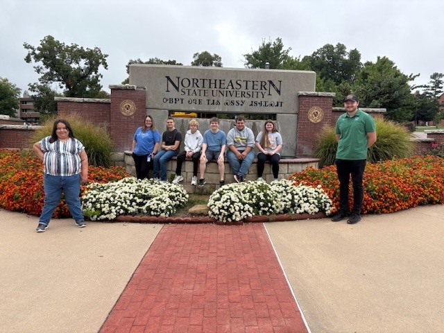 kids sitting on the NSU sign