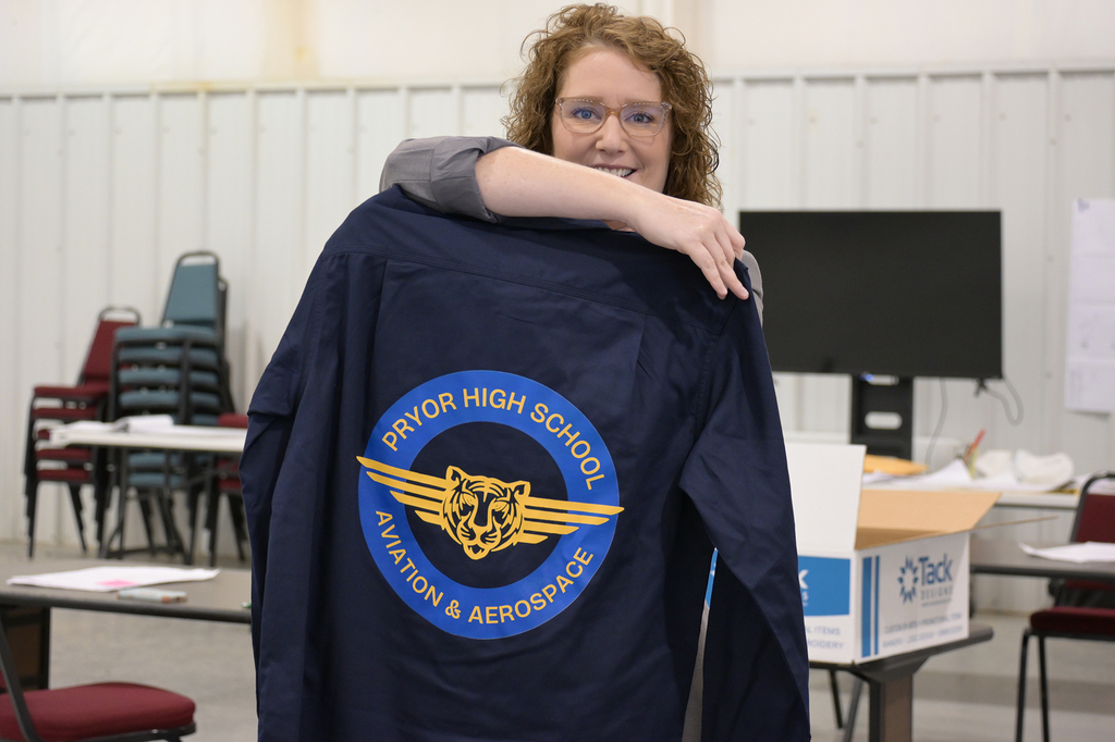 instructor holding up shirt