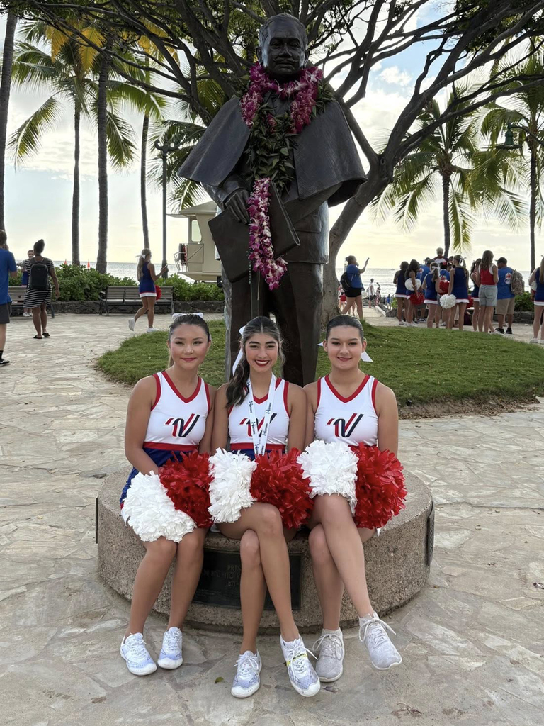 seated in front of statute
