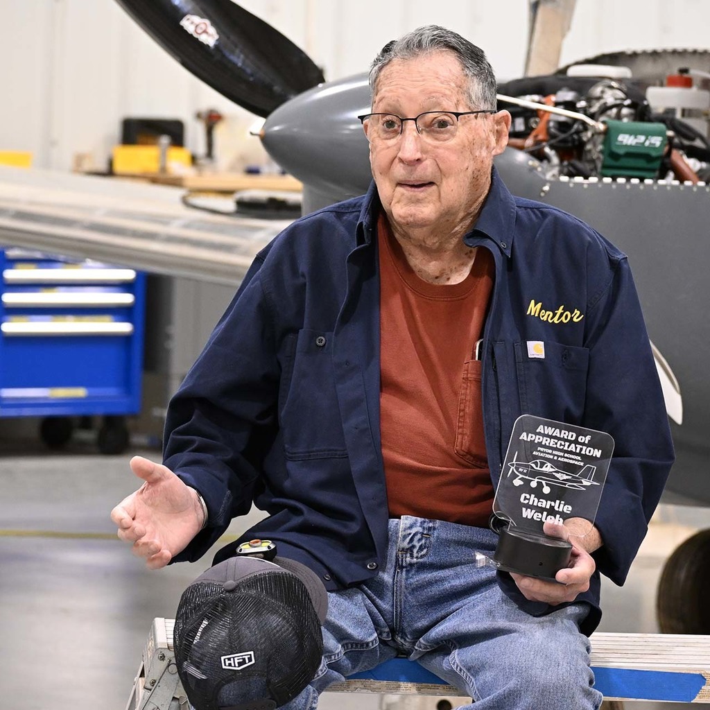 welch holds mentor plaque