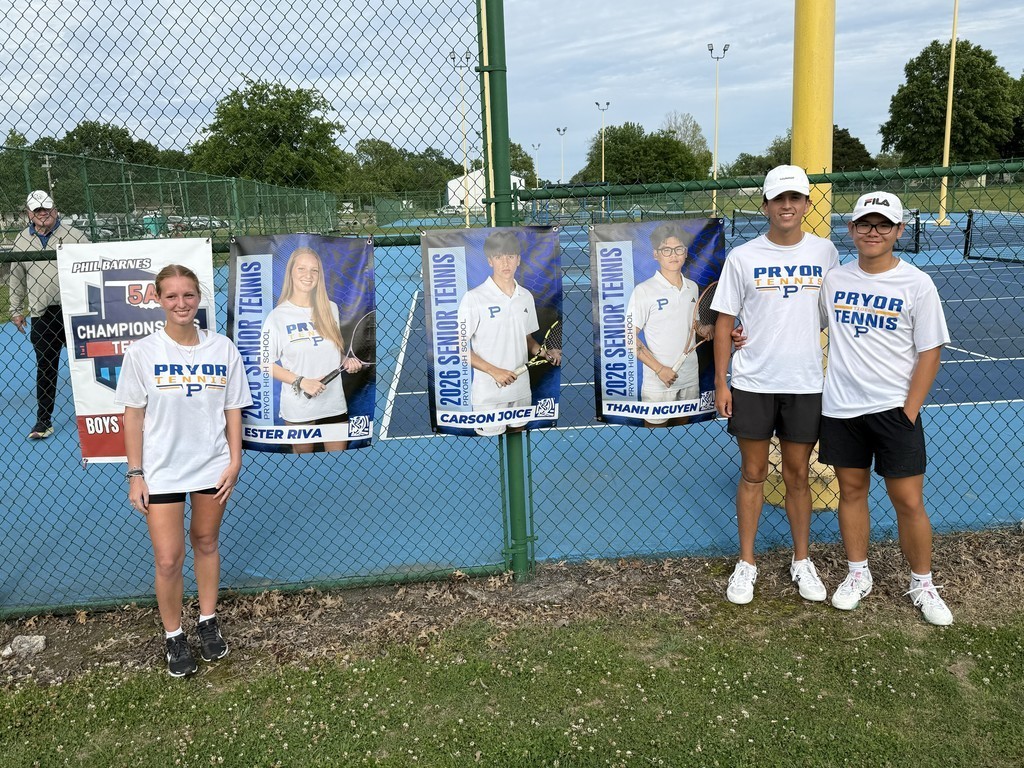 seniors stand with their athletic banners