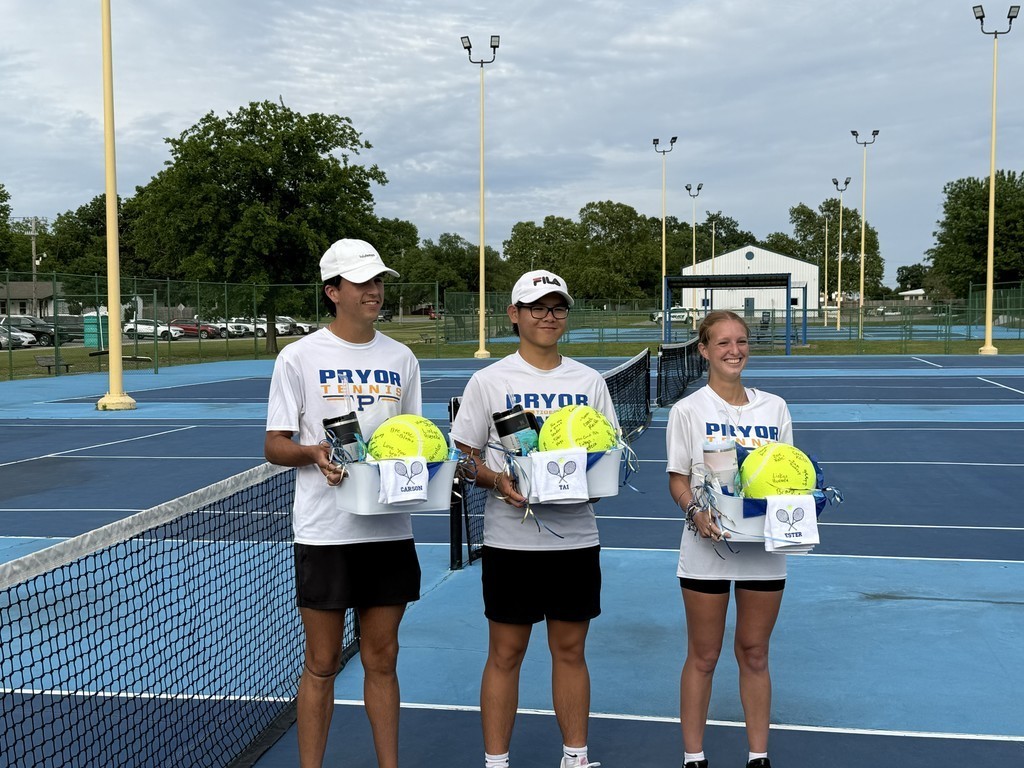 three seniors with giant signed tennis balls