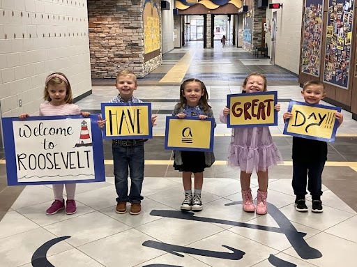 5 kids with welcome signs