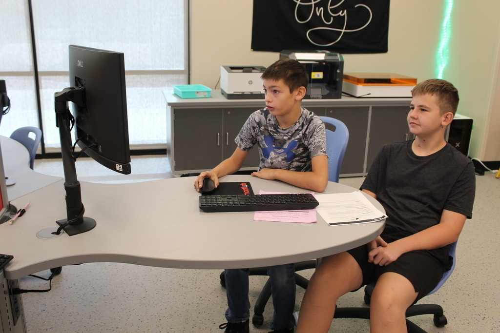 two students look at computer