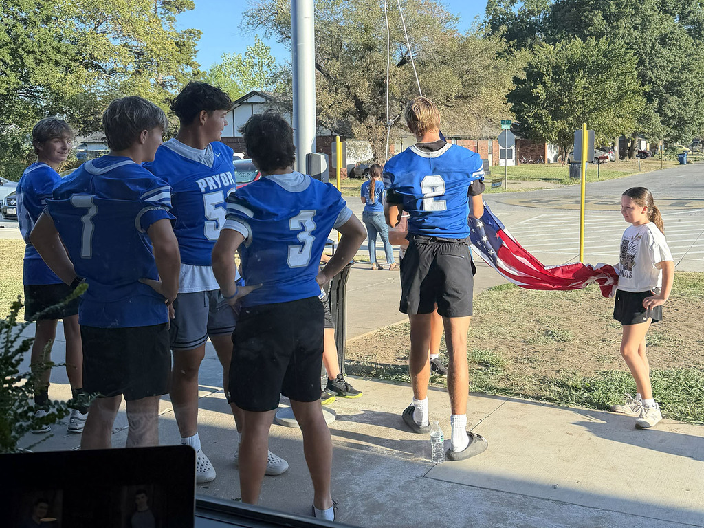 little girl helping football players