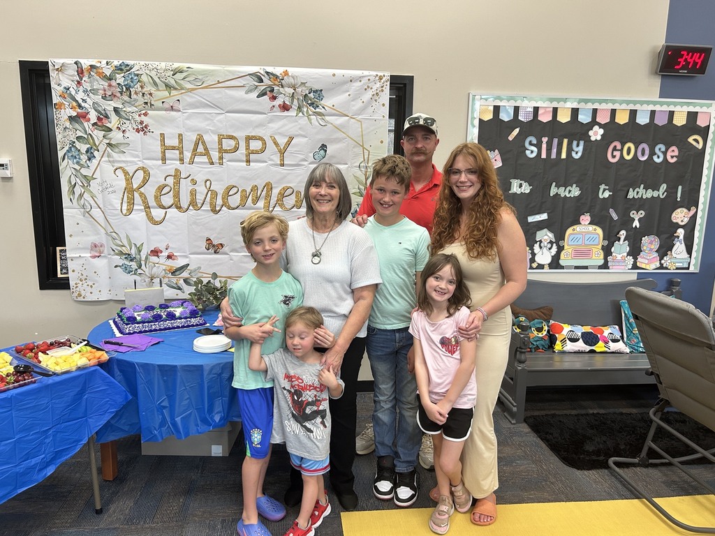 Family standing in front of retirement banner