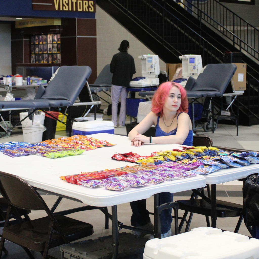 Girl sitting at the table full of snacks