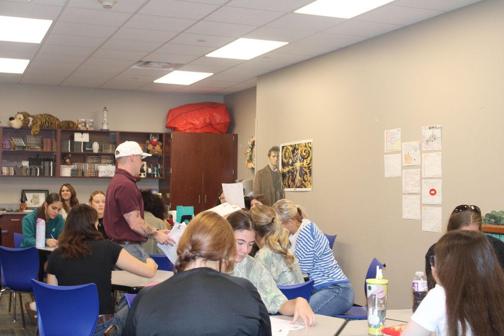 Students signing papers