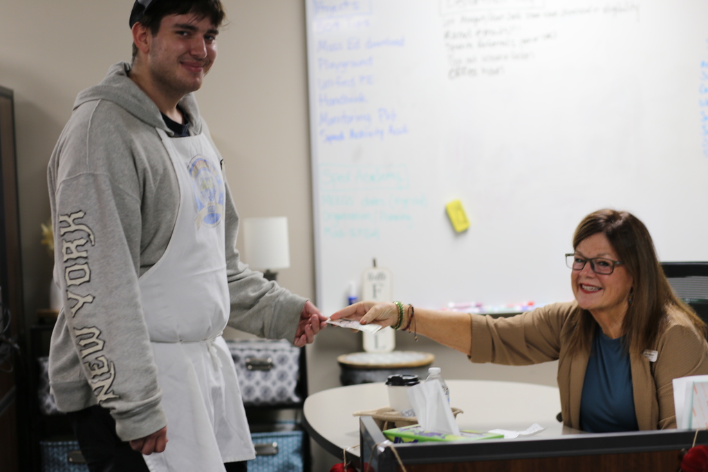 Teacher giving student money