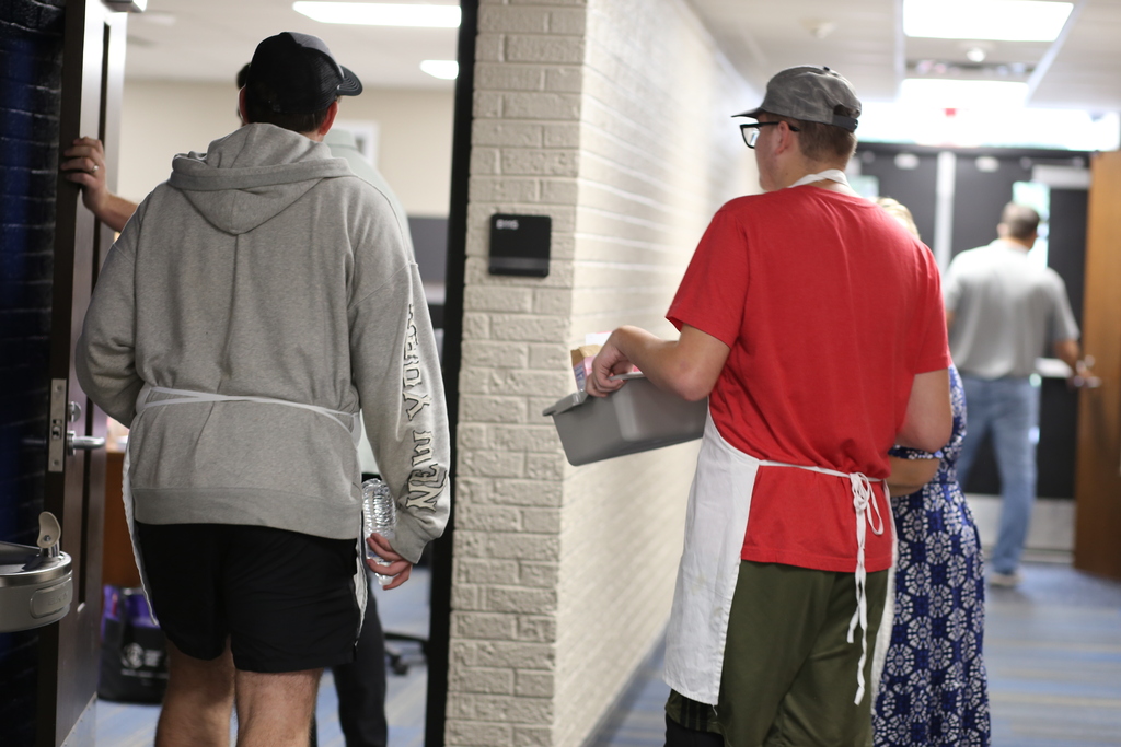 Students walking into office to give coffee