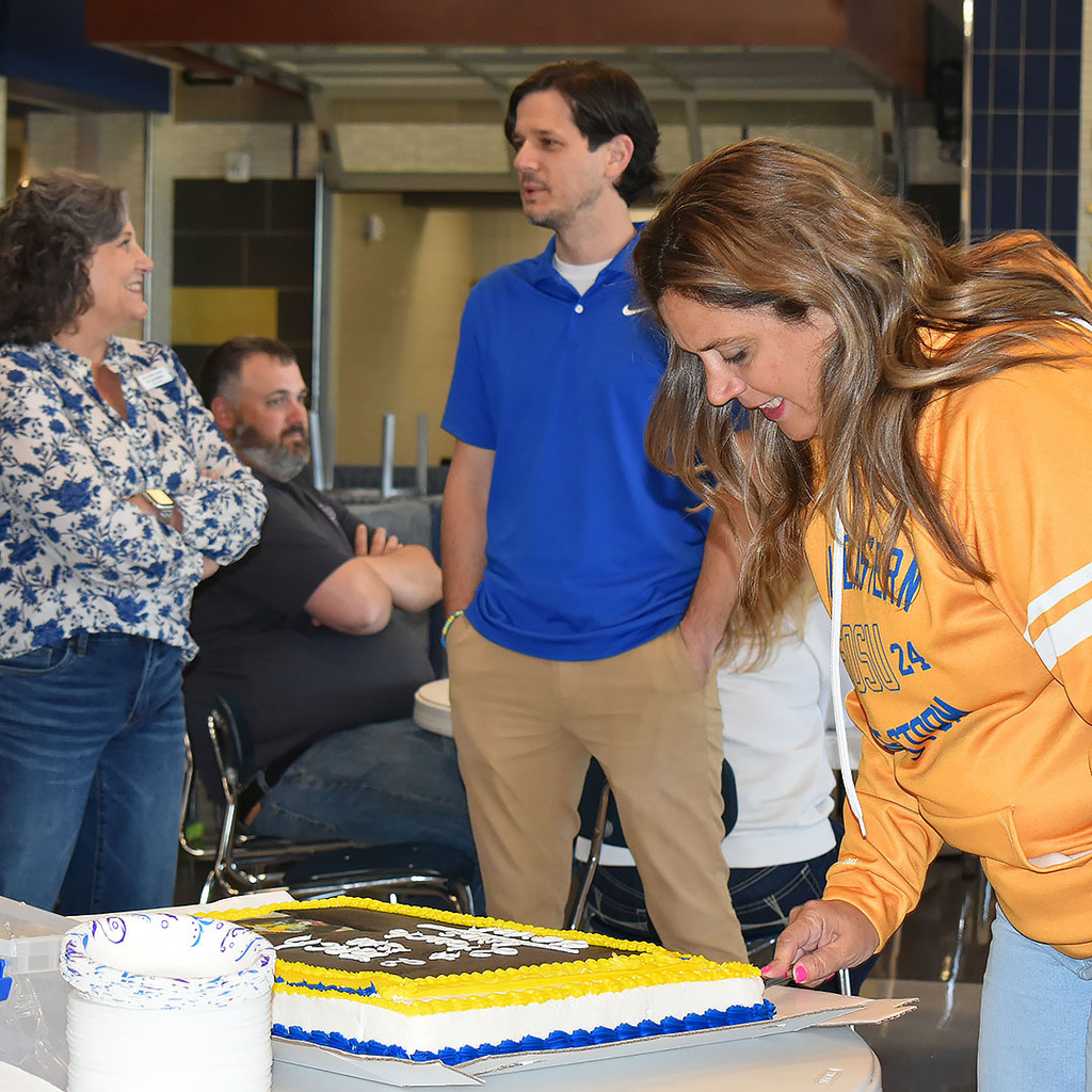 Mrs. Burroughs cuts cake