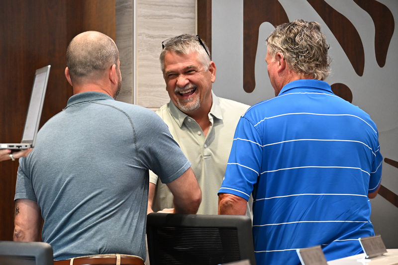 Miller shaking hands with other board members