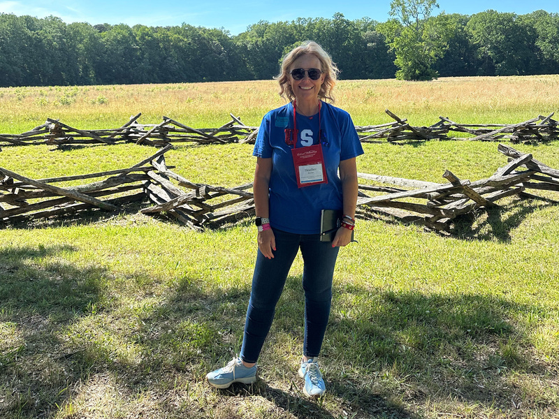 braucher in front of wooden fence