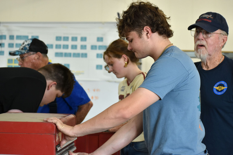 student with red toolbox