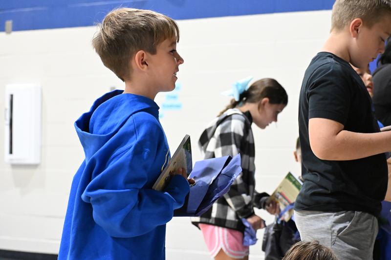 boy carrying book
